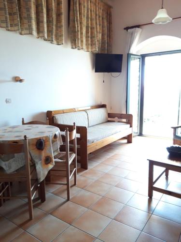 a living room with a couch and a table at Skardamoula's Studios and Apartments, 2 in Kardamili