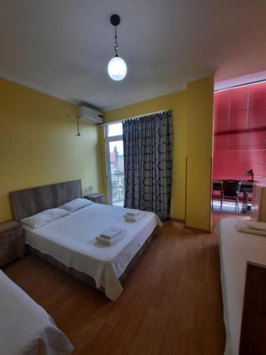 a bedroom with a large white bed and a window at Delta Hotel in Ureki