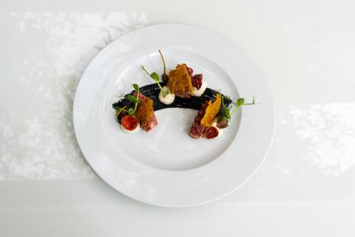 a plate of food on a white plate at Carrick Hotel Camogli Portofino Coast in Camogli