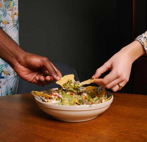 a person eating a bowl of salad with a tortilla at Hotel Malcom and Barret in Valencia