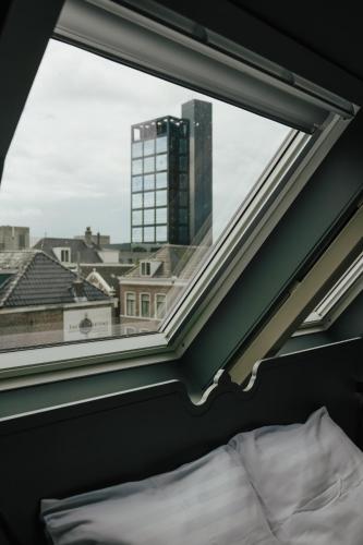 a window with a view of a city at In de Brouwerij in Leeuwarden