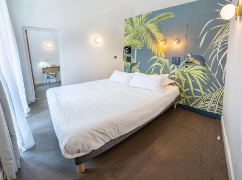 a large bed in a room with a mural at Monsieur Miot Concept Hotel - Bastia centre in Bastia