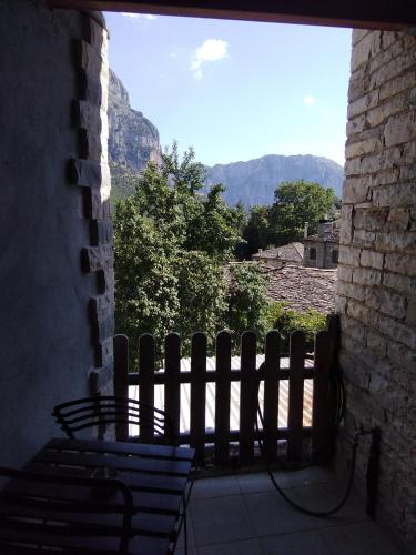 a bench sitting on a porch looking out at the mountains at Radovoli in Papigko