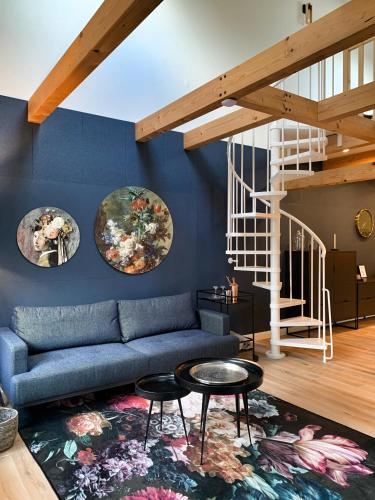 a living room with a couch and two plates on the wall at NJOLA in Sohland am Rotstein