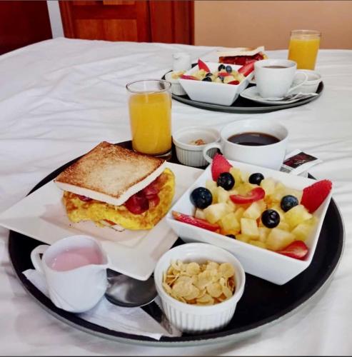 a tray of breakfast foods on a table at Victtorios Hotel in Satipo