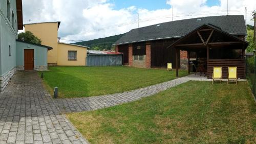 a house with a pavilion in the middle of a yard at Apartmánový dům Michael in Lipova Lazne