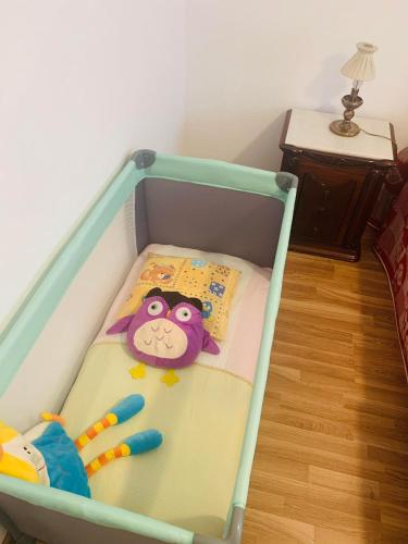 a crib with a toy monkey on it at Anjú-Pardal in Mogadouro