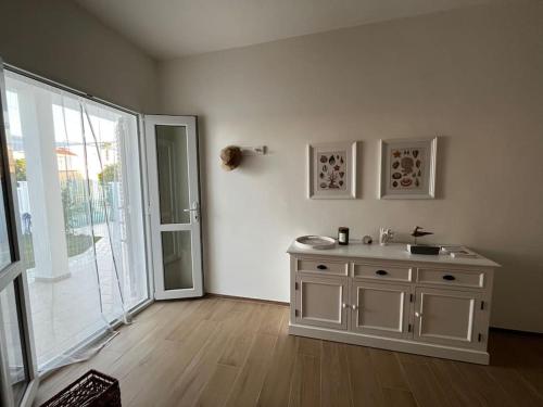 a bathroom with a sink and a sliding glass door at Casa Matilde a pochi passi dal mare in Torre Squillace
