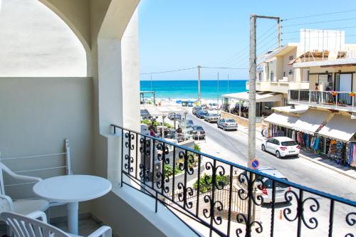 a balcony with a view of a street and the ocean at Anita Beach Hotel- Adults Only in Rethymno