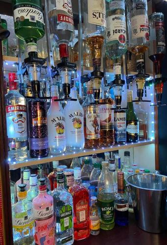a shelf filled with lots of bottles of alcohol at The Rockley Hotel in Blackpool