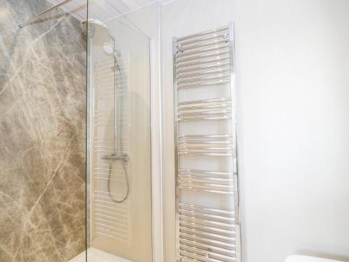 a bathroom with a shower with a glass door at Seawinds 2a in Colwyn Bay