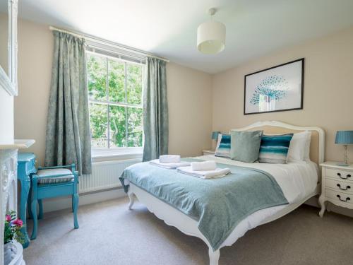 a bedroom with a bed and a window at Pass the Keys Charming 2 bed cottage with parking in Canterbury in Canterbury