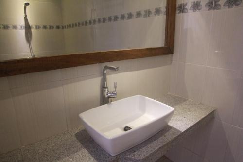 a white sink in a bathroom with a mirror at D'Camel Hotel Lembongan in Nusa Lembongan