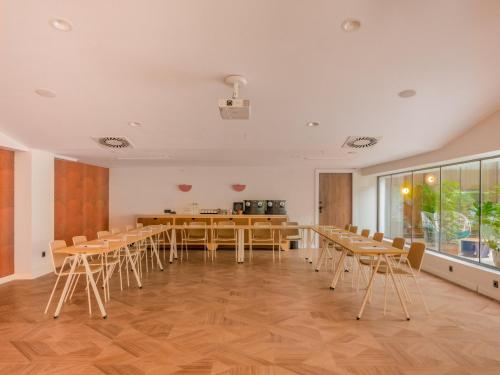 a dining room with wooden tables and chairs at Ibis Styles Sevilla City Santa Justa in Seville