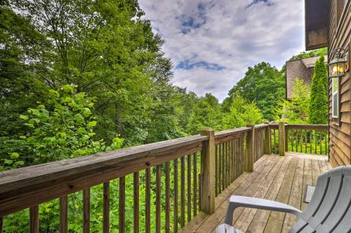 a wooden deck with a chair and a table on it at Cozy Boone Cabin with Deck Close to Downtown! in Boone
