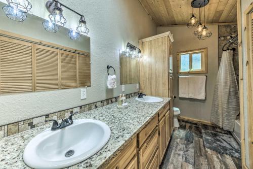 a bathroom with two sinks and a shower at Sleepy Bear Cabin in Ruidoso Deck and Yard Games! in Ruidoso