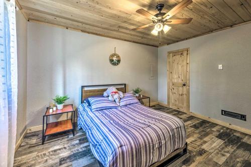 a bedroom with a bed with a stuffed animal on it at Sleepy Bear Cabin in Ruidoso Deck and Yard Games! in Ruidoso