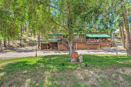 a park with a tree and a playground at Sleepy Bear Cabin in Ruidoso Deck and Yard Games! in Ruidoso