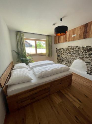 a bedroom with two beds and a window at Apartment Goaßa - Familie Zehner in Göriach