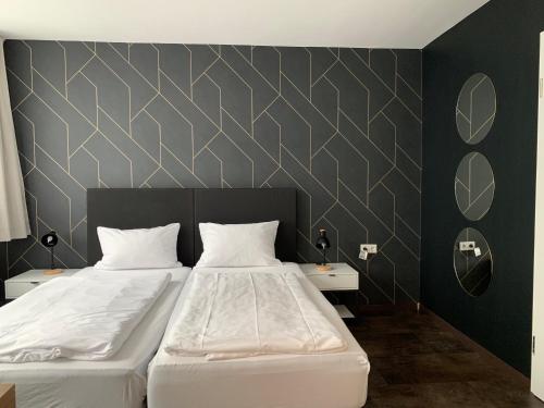 a bedroom with two beds and two night stands at MOTELO Bielefeld - Smart HOTEL in Bielefeld