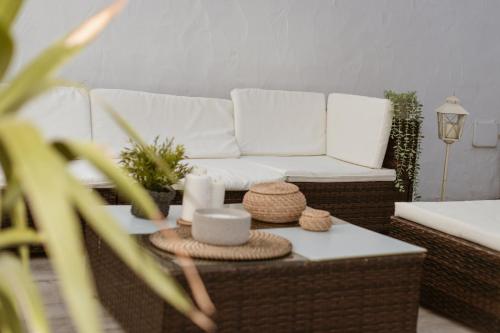 a living room with a white couch and a coffee table at El Retiro de la Adrada AVILA in La Adrada