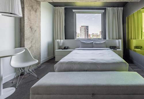 a bedroom with a large bed and a window at Hotel Zero 1 Montreal in Montréal
