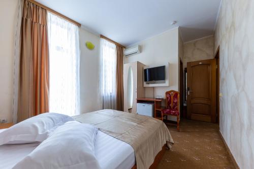 Postel nebo postele na pokoji v ubytování Hotel Amphitryon