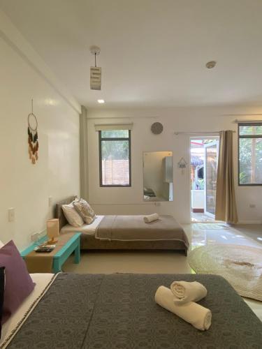 a large bedroom with a bed and a couch at Everrich Boutique Resort Boracay in Boracay