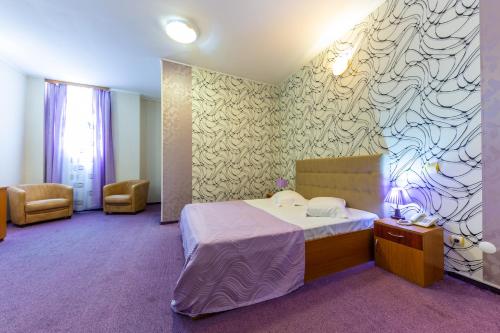 Postel nebo postele na pokoji v ubytování Hotel Amphitryon