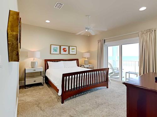 a bedroom with a large bed and a balcony at Beach Music in Gulf Shores