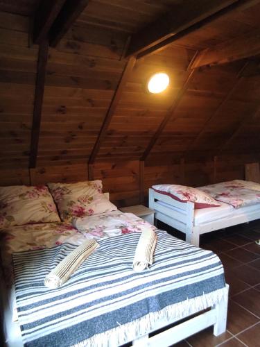 a bedroom with two beds in a attic at Dom Wakacyjny Krawno in Piecki