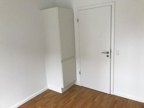 an empty room with a white closet and a door at Single Room in SHARED APARTMENT with single bed in Copenhagen