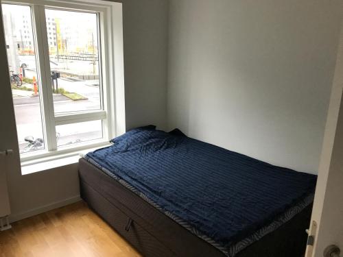 a bed in a bedroom next to a window at Single Room in SHARED APARTMENT with single bed in Copenhagen