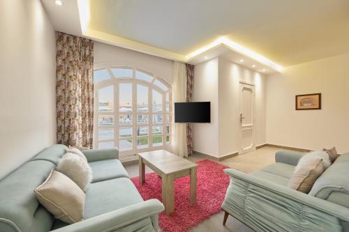 a living room with a couch and a table at Le Royal Marina Hotel in El Alamein