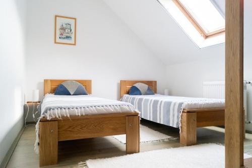A bed or beds in a room at AllOne apartman