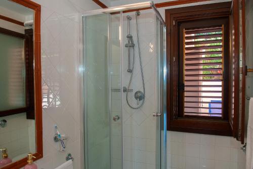 a bathroom with a shower with a glass door at SunnyHomeCefalù39 in Cefalù