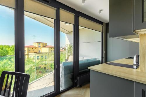 a kitchen with a large window with a view at AURUM PREMIUM SPA UNIA RESIDENCE in Lublin