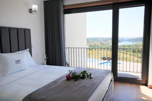 a bedroom with a large bed with a large window at Monte Bela Vista in Macedo de Cavaleiros