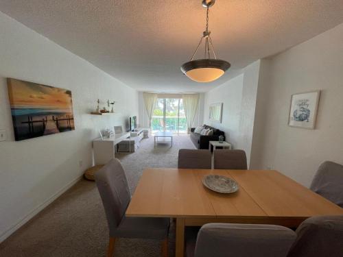 a living room with a wooden table and a dining room at Ocean Reserve 207 - STR 2270 in Miami Beach
