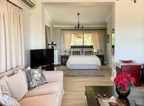 a living room with a bed and a couch at Dream Views in Somerset West
