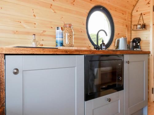 a kitchen with a sink and a microwave at Stargaze in Truro