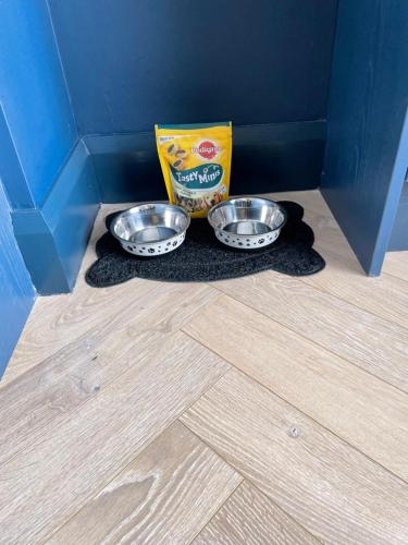 two bowls of food sitting on the floor in a room at Roe Valley Apartments in Limavady