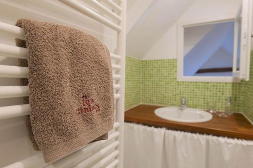 a bathroom with a sink and a towel hanging on the wall at By les Climats - L'Angevin - Gevrey-Chambertin in Gevrey-Chambertin