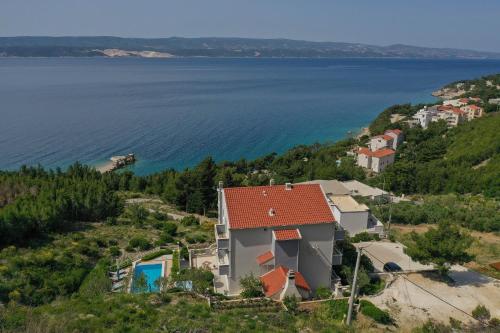 an aerial view of a house on a hill next to the water at Luxury Apartments Tafra in Lokva Rogoznica