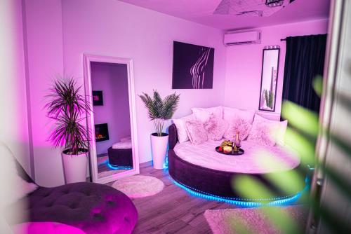 a purple room with a bed and a mirror at Apartament Craiova Modern Space Semineu Pat Rotund in Craiova