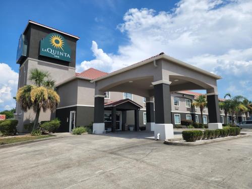 a hotel with a sign on the front of it at La Quinta by Wyndham Morgan City in Morgan City