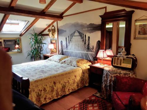 a bedroom with a bed and a painting on the wall at Studios Kono in Kotor