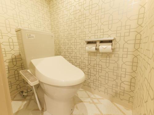 a bathroom with a white toilet in a room at Fun3 -Adult Only- in Yokohama