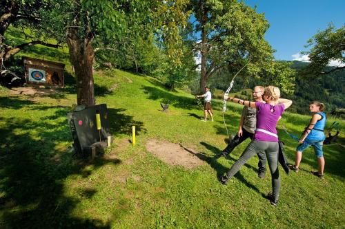 a group of people playing with kites in a field at Appartements Hartlbauer in Dorfgastein