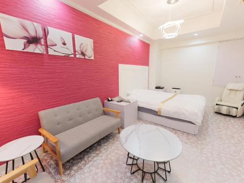 a hotel room with a bed and a couch and tables at Fun3 -Adult Only- in Yokohama